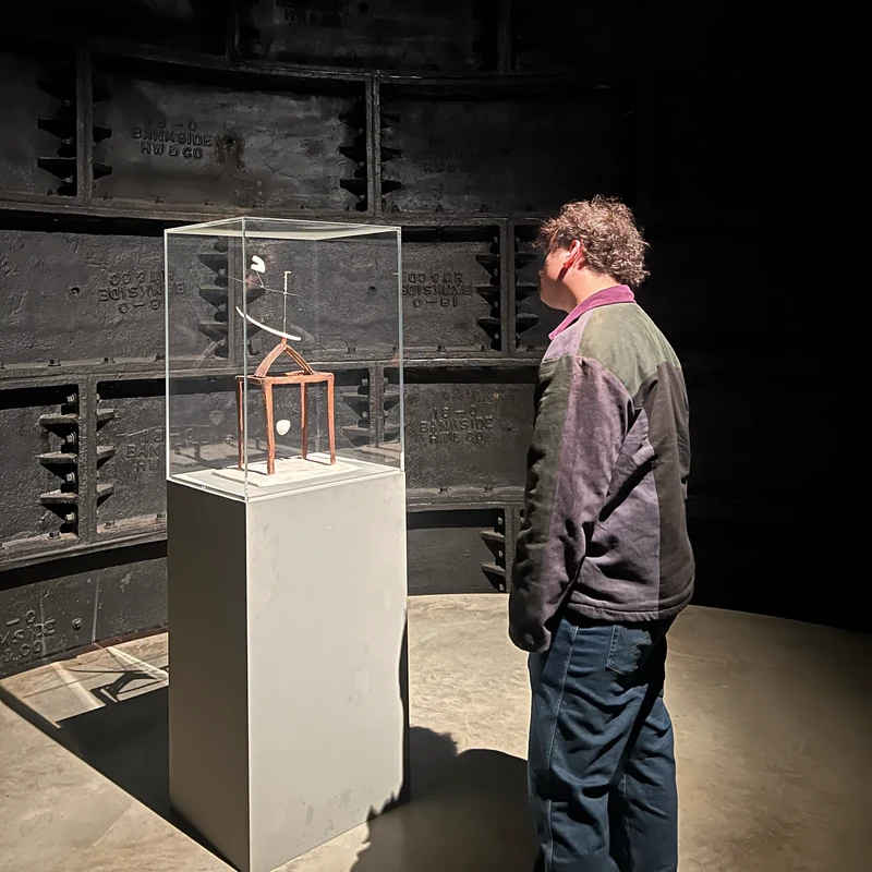 Jacob Howard looking at an artwork in a gallery.